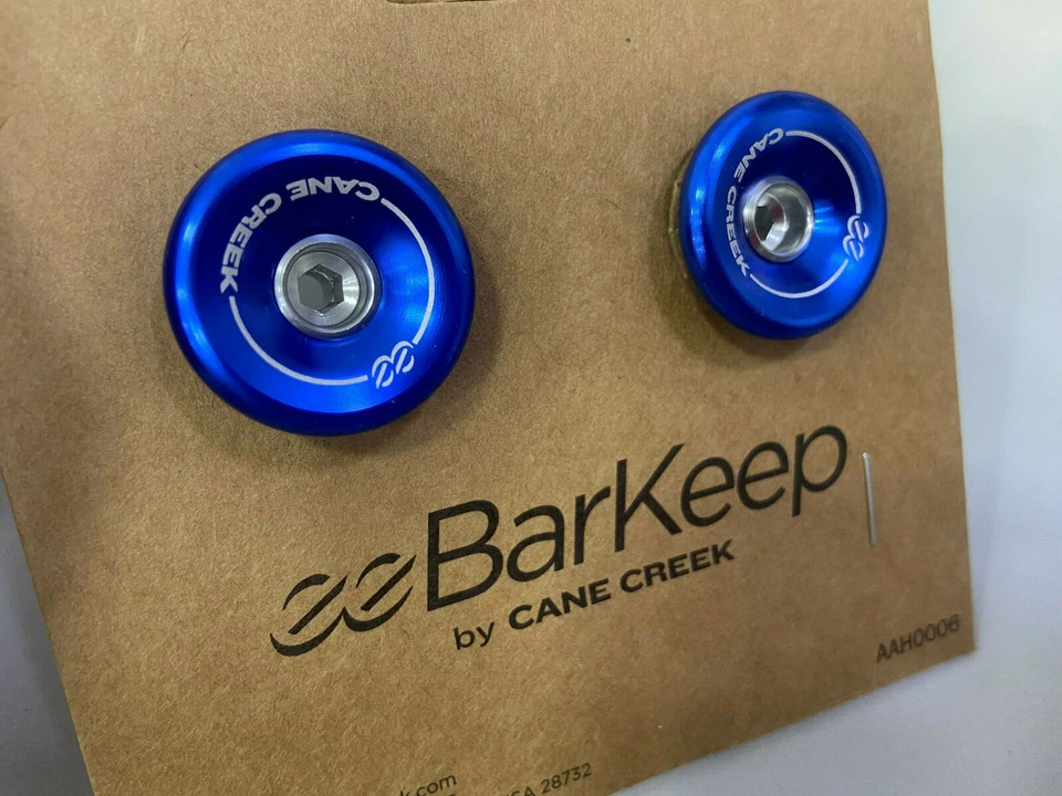 Tapones de extremo de manillar Cane Creek eeBarKeep (para barra de caída y barra plana) azul/rojo/dorado Foto 1 de 1