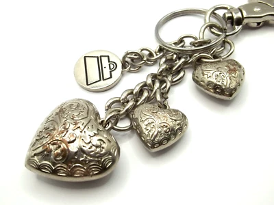 LLAVERO KATHY VAN ZEELAND TONO PLATA; CORAZONES HINCHADOS CON ENCANTO DE BOLSO Y CLIP PARA MONEDERO... Foto 1 de 4