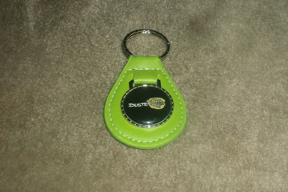 1970 1971 1972 1973 1974 1975 1976 PLYMOUTH DUSTER CLOUD LOGO KEYCHAIN GREEN - Image 1 of 1