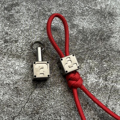 Llavero Titanio Paracaídas Cordón Cuentas Colgante Cuchillo Cordón EDC Cuentas Cremallera Cabeza Foto 1 de 4