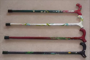 Set of four hand painted canes, each approximately 31" tall. Gently worn - Picture 1 of 2