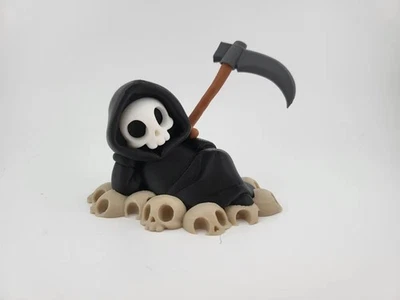 Chillin' Grim Reaper Skeleton Figure on Skull Pile - Image 1 of 4