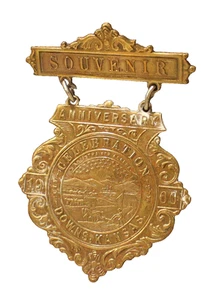 27 de julio de 1900 Downs Kansas recuerdo aniversario celebración medalla de latón insignia - Imagen 1 de 3