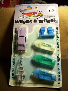 VINTAGE MIDGETOY-WAVES AND WHEELS SET ON CARD-MUSTANG, TRAILER AND BOATS.
