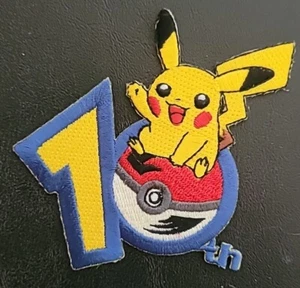 Pokémon 10. Jahr. Journey Across America Aufnäher • bestickt • Aufbügeln • unbenutzt - Bild 1 von 2