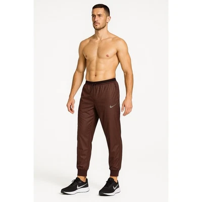 Pantalones deportivos Nike para hombre grandes marrones para correr división Phenom Storm-FIT Athleisure Foto 1 de 4