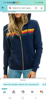 NUEVA DYRUNUL Sudadera con Capucha Negra Para Mujer Talla S Con Rayas Arco Iris y Cierre de Cremallera Dorada. Foto 1 de 2