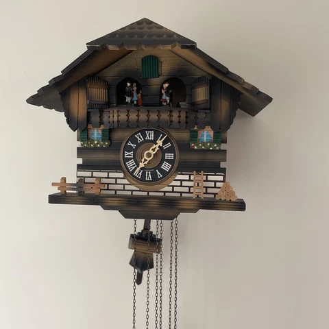 Colorful, Chalet Cuckoo Clock with revolving figures.8.75” Tall  11.75” Wide Cover