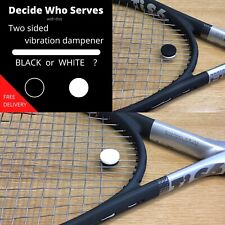 Tennis vibration dampener.  Black on one side, white on the other. 