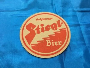Collectable drink coaster -“SALZBURGER STIEGLITZ BIER” NEW Perfect Condition  - Picture 1 of 3