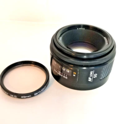 Vintage Minolta MAXXUM AF 50mm 1:1.7(22) w Rolev M.G. 49mm Skylight Filter - Image 1 of 4
