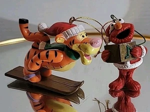 Two Vintage Ornaments Christmas Tigger Skiing And Elmo Caroling Heavily Used - Picture 1 of 11