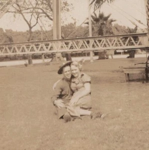 1940s Couple Grass Bridge Background Woman Seated Man Lap Portrait - Picture 1 of 3