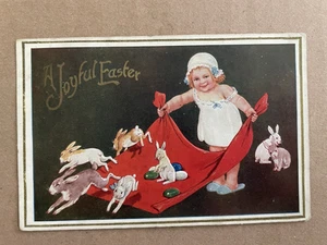 Vintage POSTCARD 1911 Joyful Easter Bunny Rabb its Eggs Girl holding Blanket - Picture 1 of 2