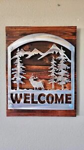 Heat treated stainless steel  elk welcome sign mounted off of torched wood