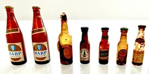 SEVEN COLLECTABLE VINTAGE MINIATURE SOUVENIR BEER BOTTLES - Picture 1 of 2