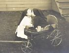 RPPC 2 Toddlers in Stocking Caps Kissing Pull Along Wagon Pioneer Express 1910s