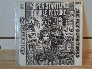 Entombed (Swe) / New Bomb Turks (USA) - Split 7" Vinyl (1995) First Pressing - Bild 1 von 4