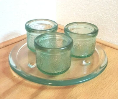 3 LIGHT GREEN RECYCLED GLASS CANDLE HOLDERS NESTED ON 3 FOOTED PLATE - Image 1 of 4