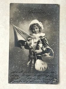 C2621 Postcard Christmas Greetings Little girl with Santa Doll Parasol and gifts - Picture 1 of 2