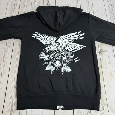 Sudadera con Capucha Cremallera Completa Tatuaje Corazón Sangrado Sudadera con Capucha Mujer Pequeña Águila Negra Foto 1 de 4