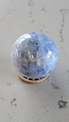 Natural Blue Celestite Crystal Sphere With Wooden Coin Stand - 350G - Image 1 of 4
