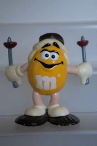 M&M'S RARE FIGURINE BOUCHON CACAHOUETTE JAUNE EN RAQUETTE 6,5 CM HAUT SANS SOCLE - Imagen 1 de 1