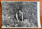 Beautiful girl sitting among poppies on nature, attractive woman. Vintage photo