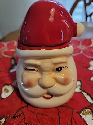 Vela de Santa guiñando un ojo con tapa 5 oz Foto 1 de 4