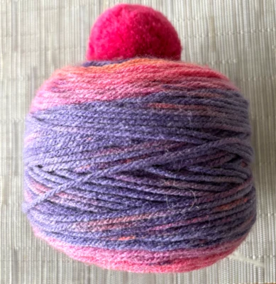 1-3.5 oz Cake of CARON CUPCAKE multi color YARN with pompom - Image 1 of 2