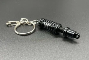Schlüsselanhänger Federbein Fahrwerk Schwarz Turbo Tuning Motor Auto - Bild 1 von 2