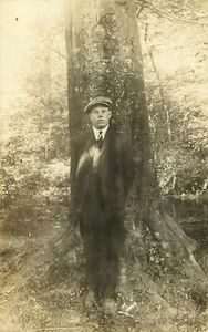RPPC Young Man with News Boy Hat Cap in front of Tree 1920's Postcard - Picture 1 of 2