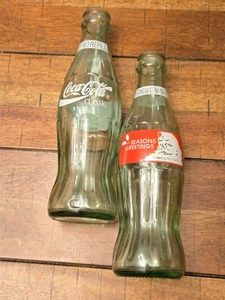 2 Vintage Christmas 8 oz Green Glass Coke SEASONS GREETINGS Commemorative Bottle - Picture 1 of 4