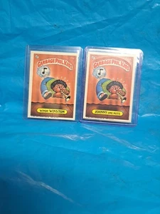 Topps Garbage Pail Kids Windy Winston #175a & Johnny One-Note 175b 1986 lote de 2 - Imagen 1 de 2