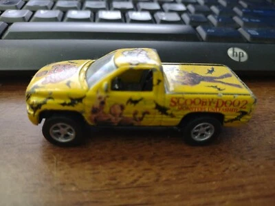 RACING CHAMPIONS 96 DODGE RAM, SCOOBY DOO 2, YELLOW 1:64 SCALE used loose - Image 1 of 4