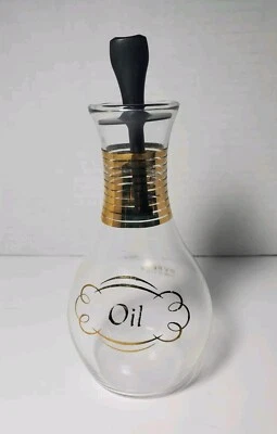 Crueta de aceite de vidrio Pyrex vintage negra y dorada con tapón Foto 1 de 4