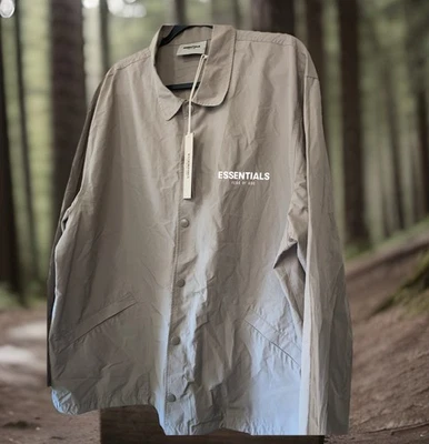 Chaqueta cortavientos Essentials Fear Of God gris manga larga frontal a presión grande para hombre Foto 1 de 4