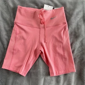 Nike Women's Tight Mid Rise Ribbed Panel Running Shorts Pockets Coral XS New - Picture 1 of 11
