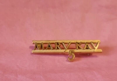 Prendedor/broche maquillaje Mary Kay tono dorado 5 años  Foto 1 de 3