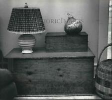 1989 Press Photo Boxes, lamps, baskets and pear combined for a still-life layout