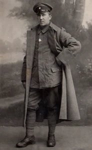 RPPC WWI Wehrmacht Soldat im Trenchcoat Echtfoto Postkarte - Bild 1 von 3
