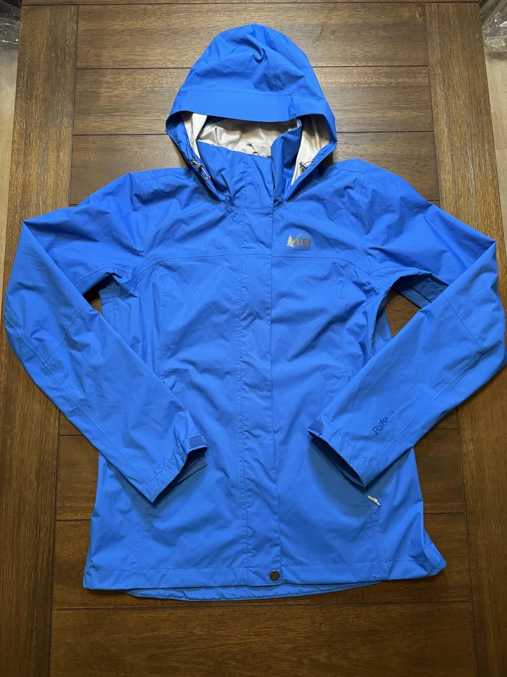 Chaqueta de lluvia cooperativa REI para mujer pequeña azul con capucha impermeable pico 2,5 L transpirable Foto 1 de 4