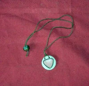 PINK TRIANGLE ON CLAY DISC PENDANT ON CORD - Picture 1 of 1