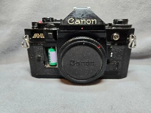 Appareil photo argentique 35 mm Canon A-1 reflex noir boîtier seul testé fonctionne - Photo 1 sur 10