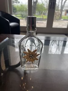Bottiglia vintage Edelweiss vetro trasparente fiore arrotolato - Foto 1 di 8