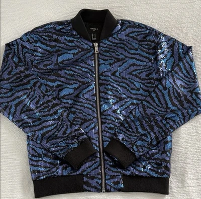 Jaqueta de lantejoulas elegante com padrão preto e azul ousado. Ideal para passeios da moda - Imagem 1 de 3