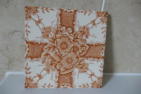 VICTORIAN POTTERY 15.2CM SQUARE TILE WITH BROWN CROSS + CENTRAL FLOWERS & LEAVES Cover