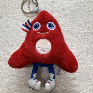 Paris 2024 Olympics Mascot Plush Keychain Red Triangle Toy Blue Eyes Used - Picture 1 of 6