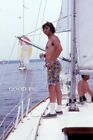 #LX - ein Vintage 35 mm Diafoto - Mann auf Boot - Gay Int - 1973