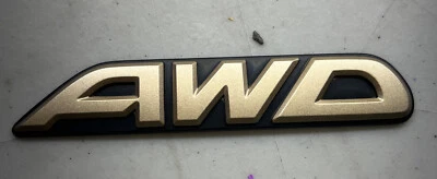 Subaru OEM 2000-2003 Outback Limited "AWD" Gold Rear Trunk Lid Emblem Logo Badge - Image 1 of 2